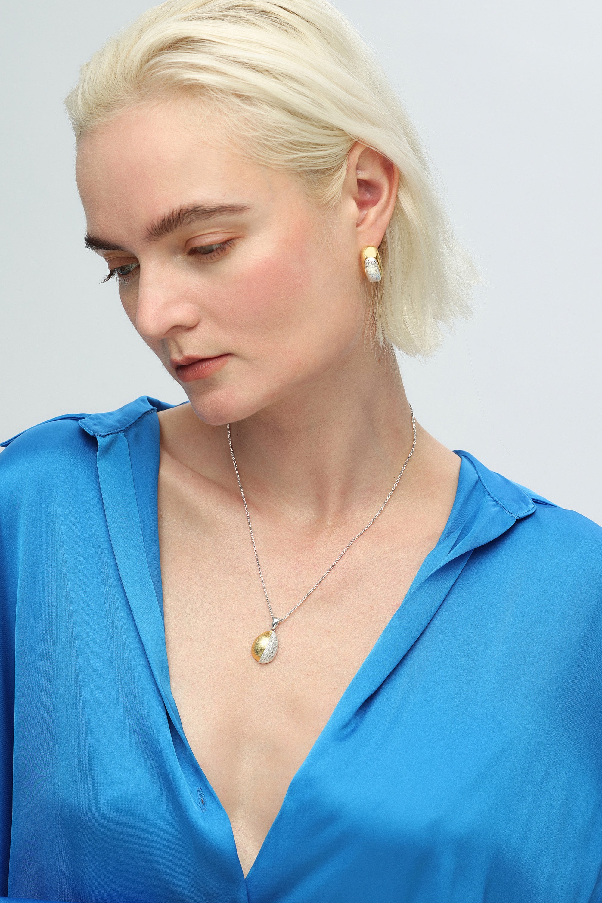 Frosted and Matted Texture Two Tone Hoop Earrings featuring silver nuggets and a gold frame, showcasing a chic and elegant design.