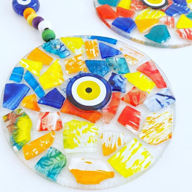 Handmade fused glass wall decor featuring a vibrant evil eye design, perfect for home decoration.
