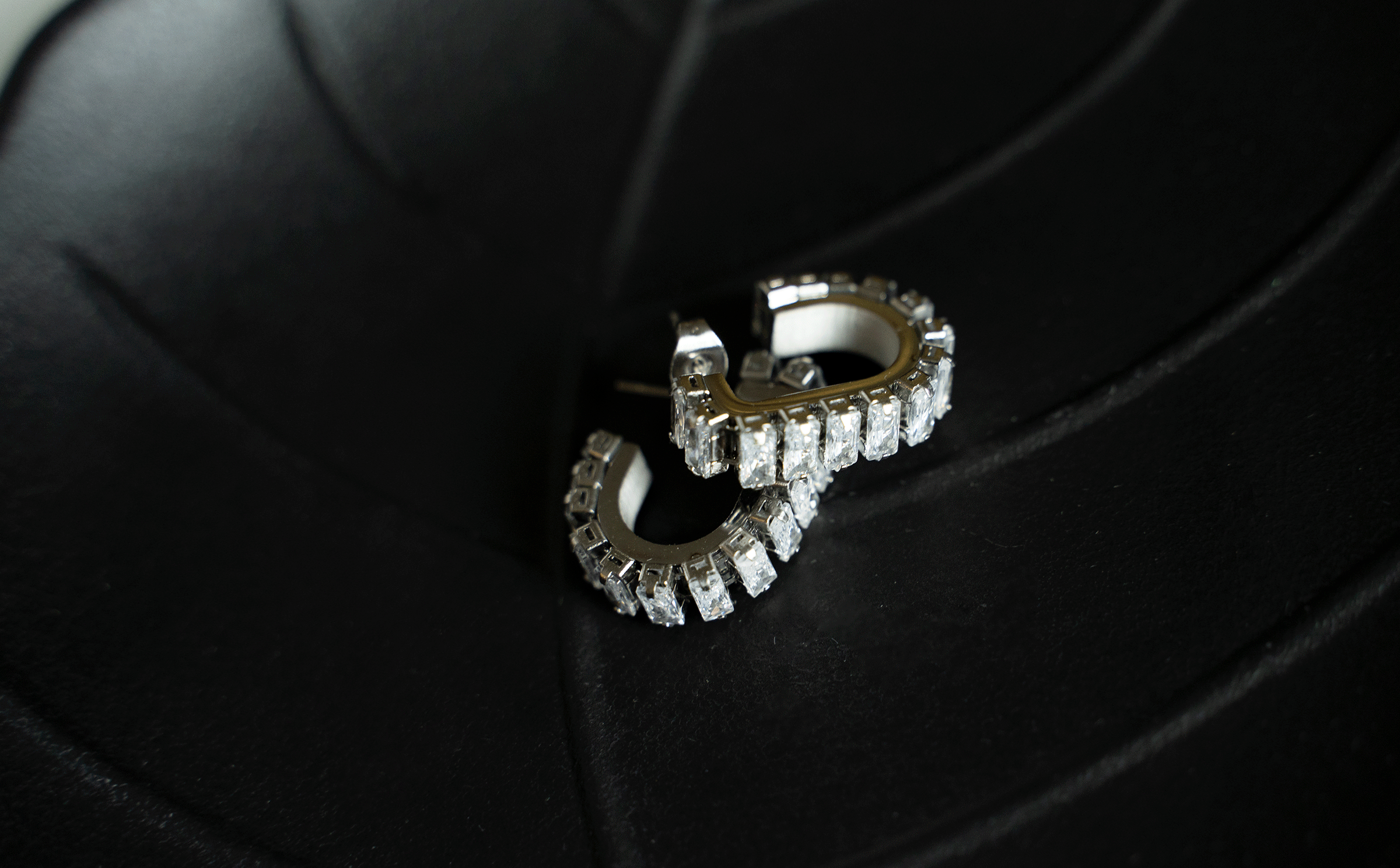 GEMMA Hoops featuring 18k gold plated stainless steel with baguette cut stones in a geometric u-shaped design.