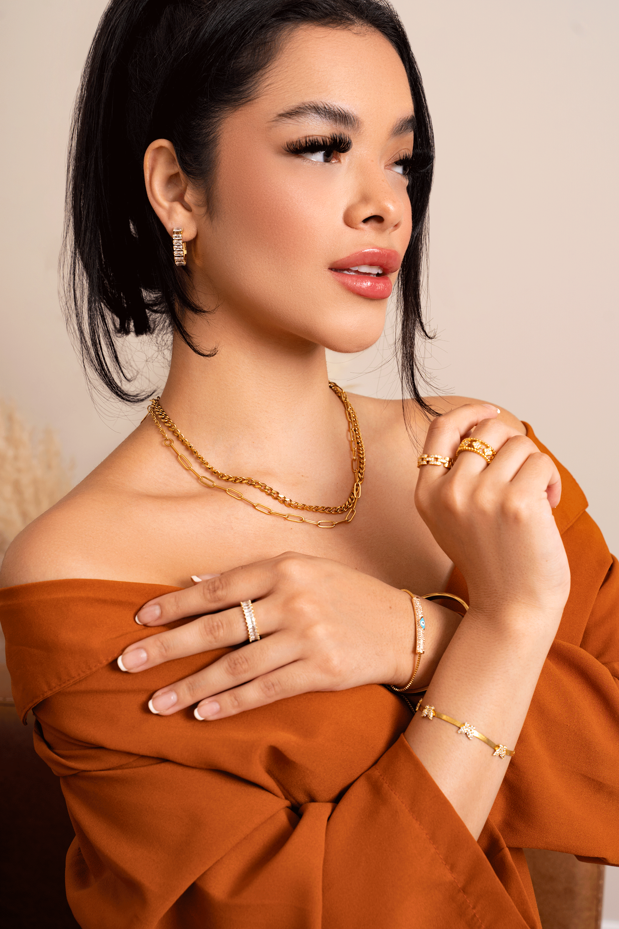 GEMMA Hoops featuring 18k gold plated stainless steel with baguette cut stones in a geometric u-shaped design.