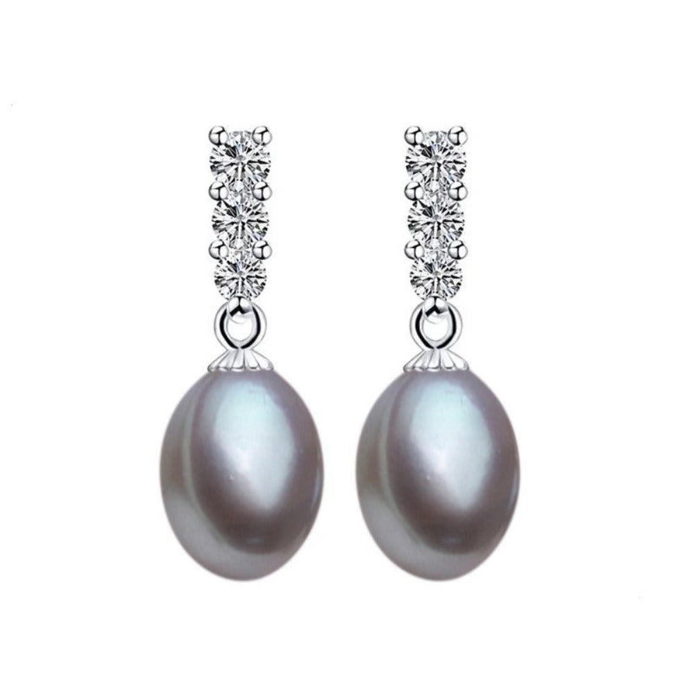 A pair of elegant drop earrings featuring genuine freshwater pearls in various colors, adorned with simulated diamonds for added sparkle.