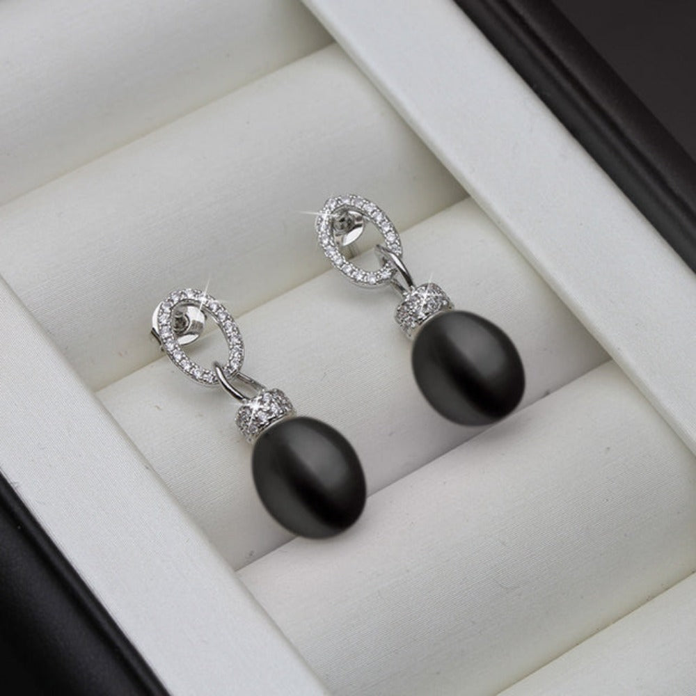 Elegant drop earrings featuring genuine freshwater pearls in various colors with simulated diamonds, showcasing their unique luster and design.