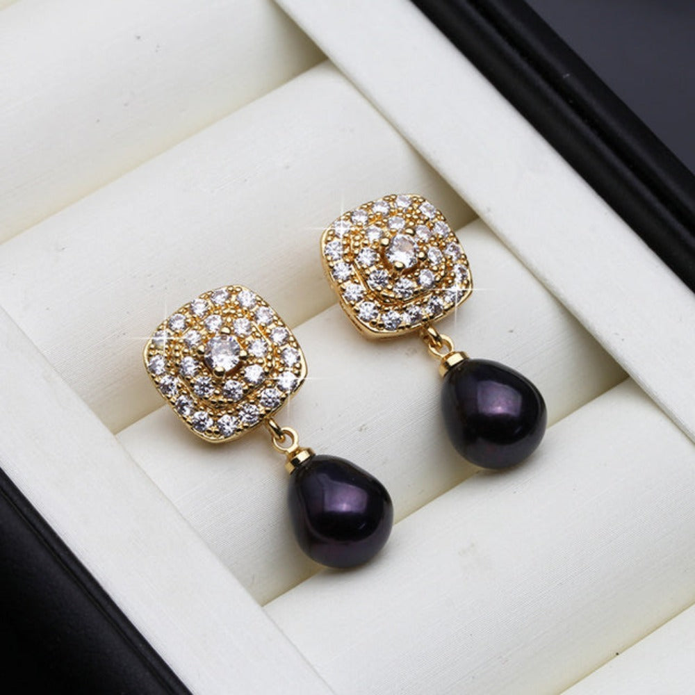 Elegant drop earrings featuring genuine freshwater pearls and simulated diamonds set in gold, available in various colors.