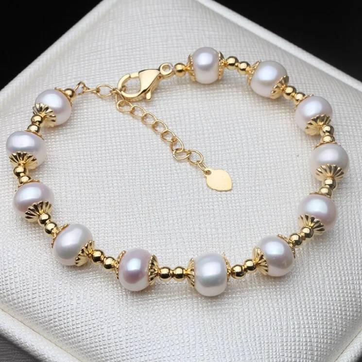 A beautiful Genuine Freshwater White Pearl Bracelet featuring white pearls and gold accents, elegantly displayed on a soft surface.