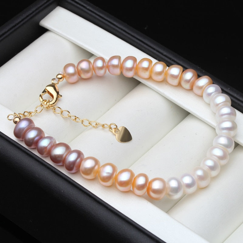 Adjustable bracelet featuring genuine pink, purple, and white freshwater pearls with gold accents.