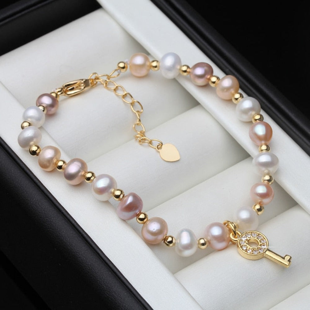 Genuine Pink, Purple & White Freshwater Pearl Key Bracelet in Gold featuring vibrant pearls and a stylish gold key charm.