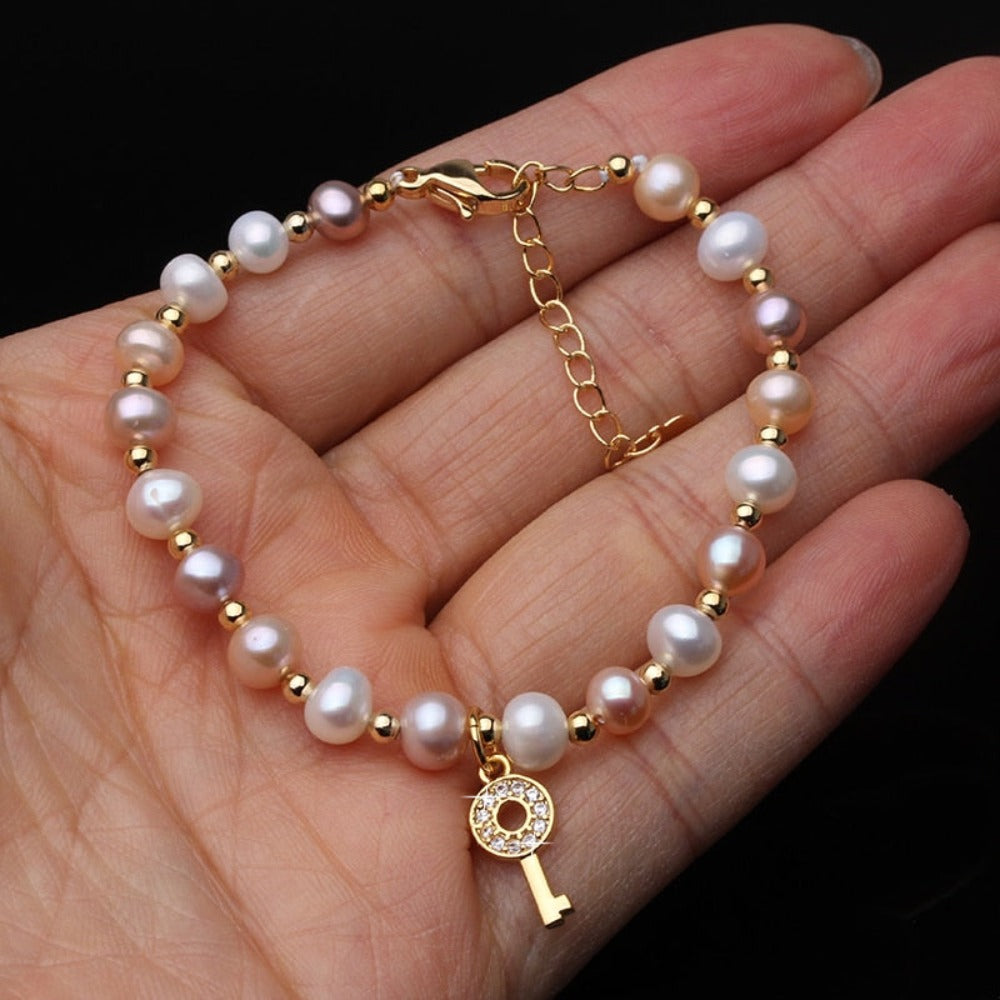 Genuine Pink, Purple & White Freshwater Pearl Key Bracelet in Gold featuring vibrant pearls and a stylish gold key charm.