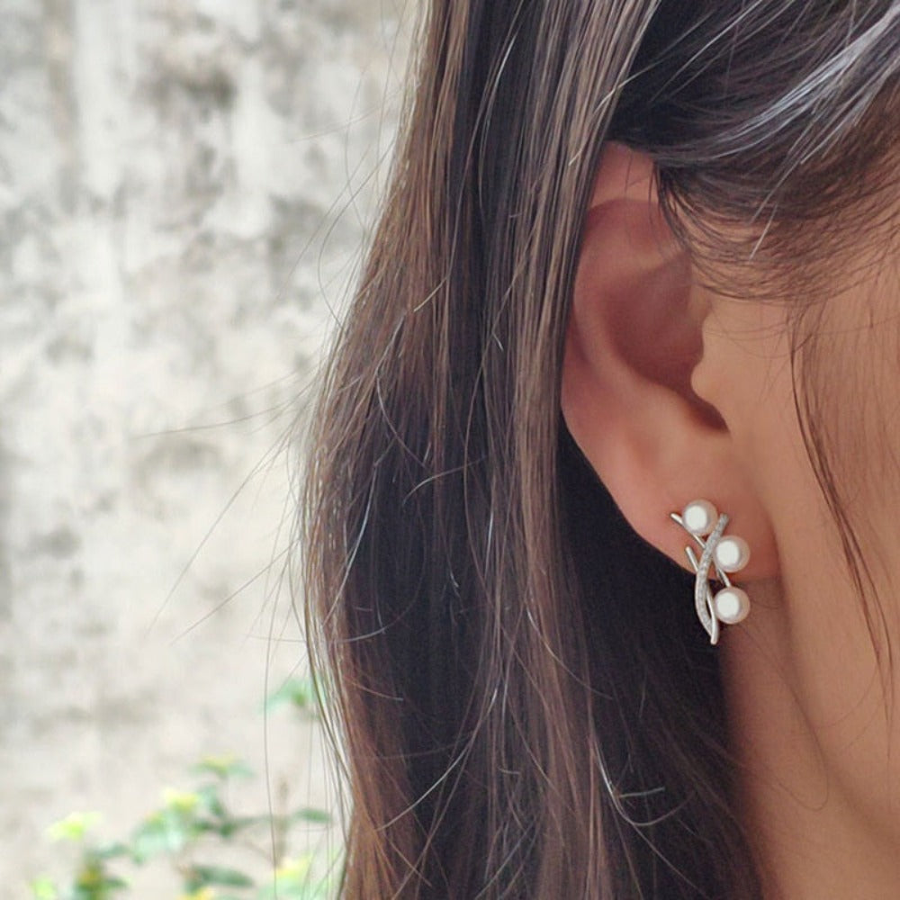 Elegant Genuine Triple Freshwater Pearl and Simulated Diamond Stud Earrings showcasing three pearls and sparkling accents.