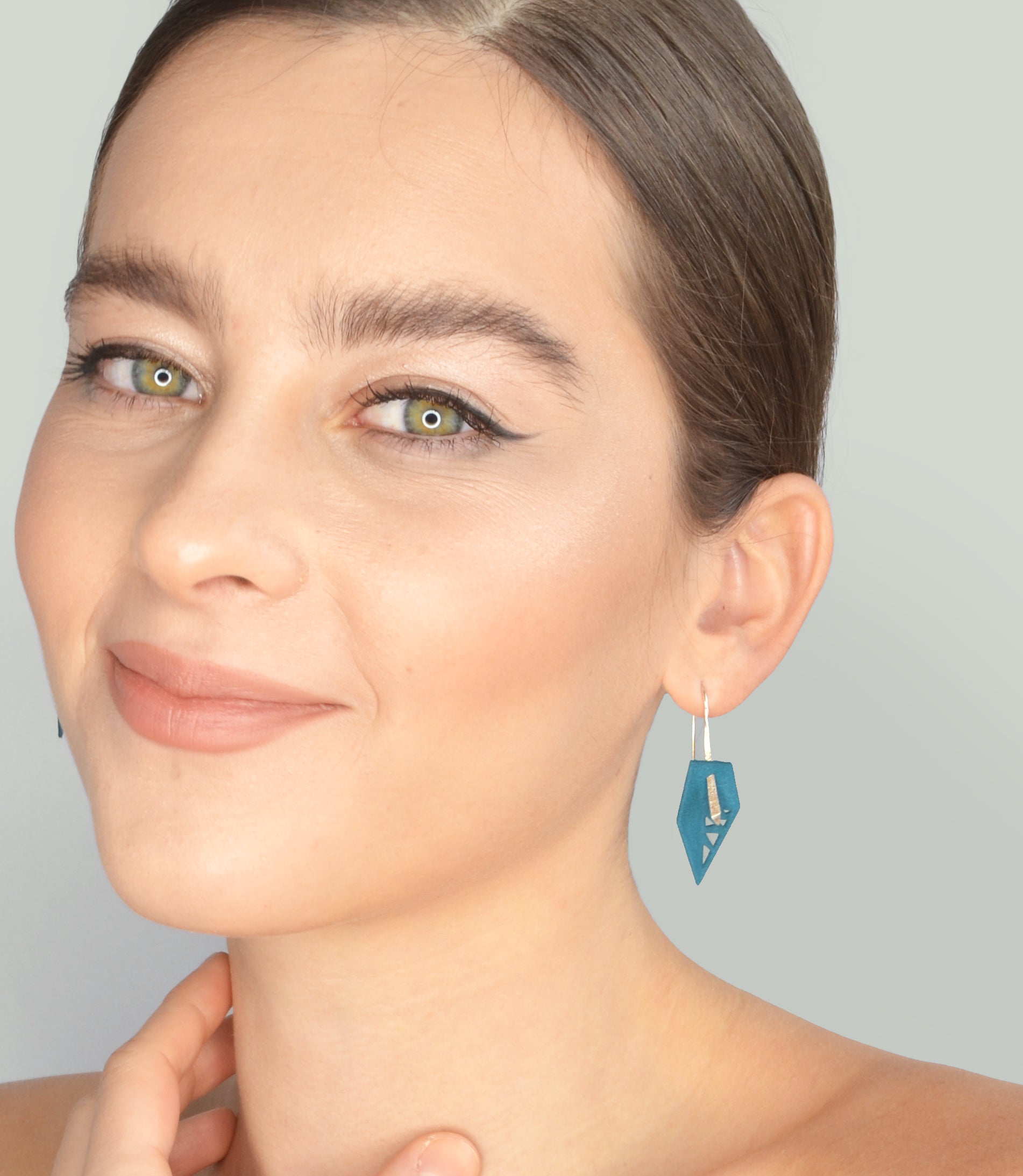 A pair of vibrant Geometric Drop Interchangeable Earrings in various colors, showcasing their unique teardrop design and lightweight structure.
