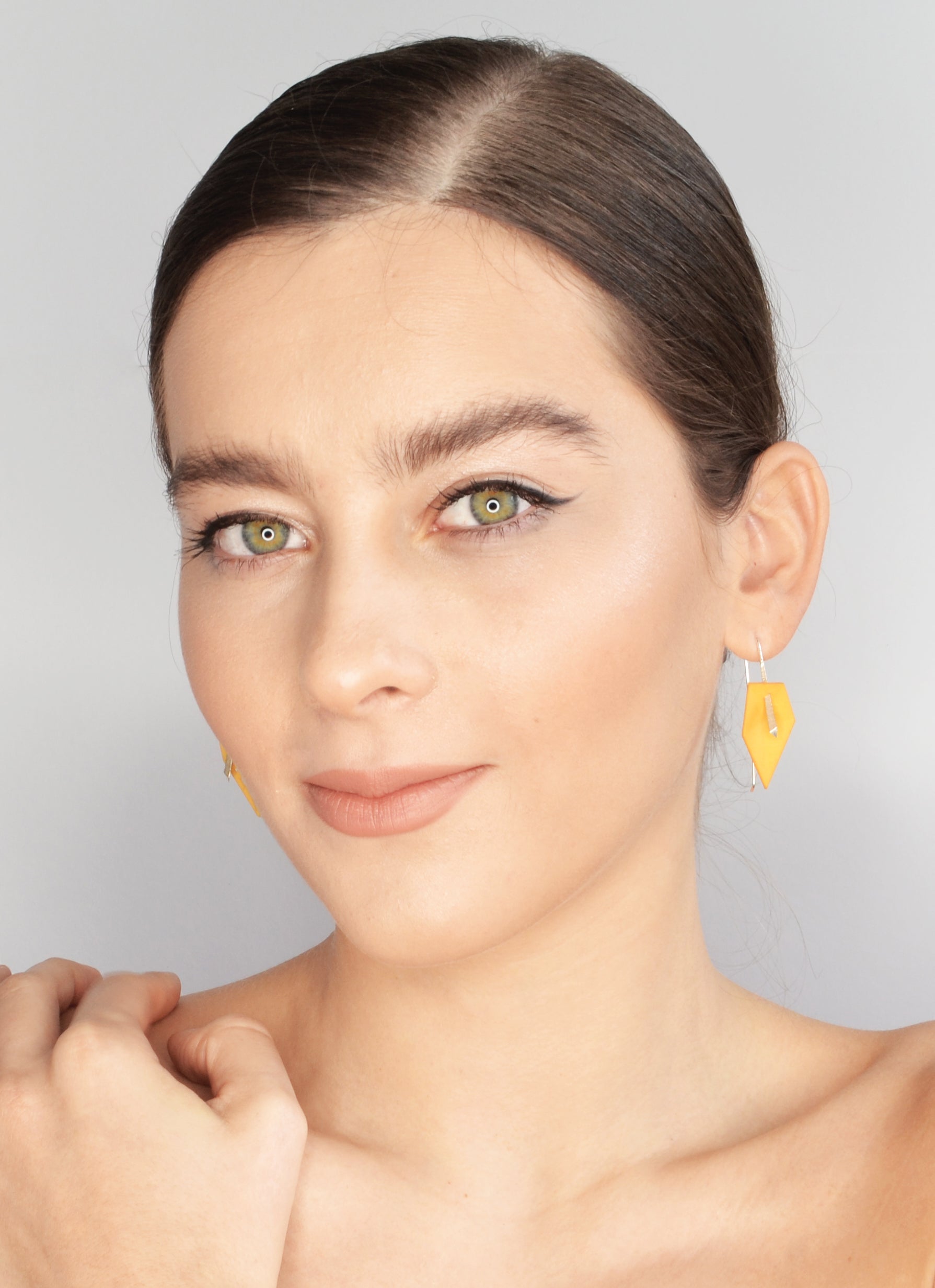 A pair of vibrant Geometric Drop Interchangeable Earrings in various colors, showcasing their unique teardrop design and lightweight structure.