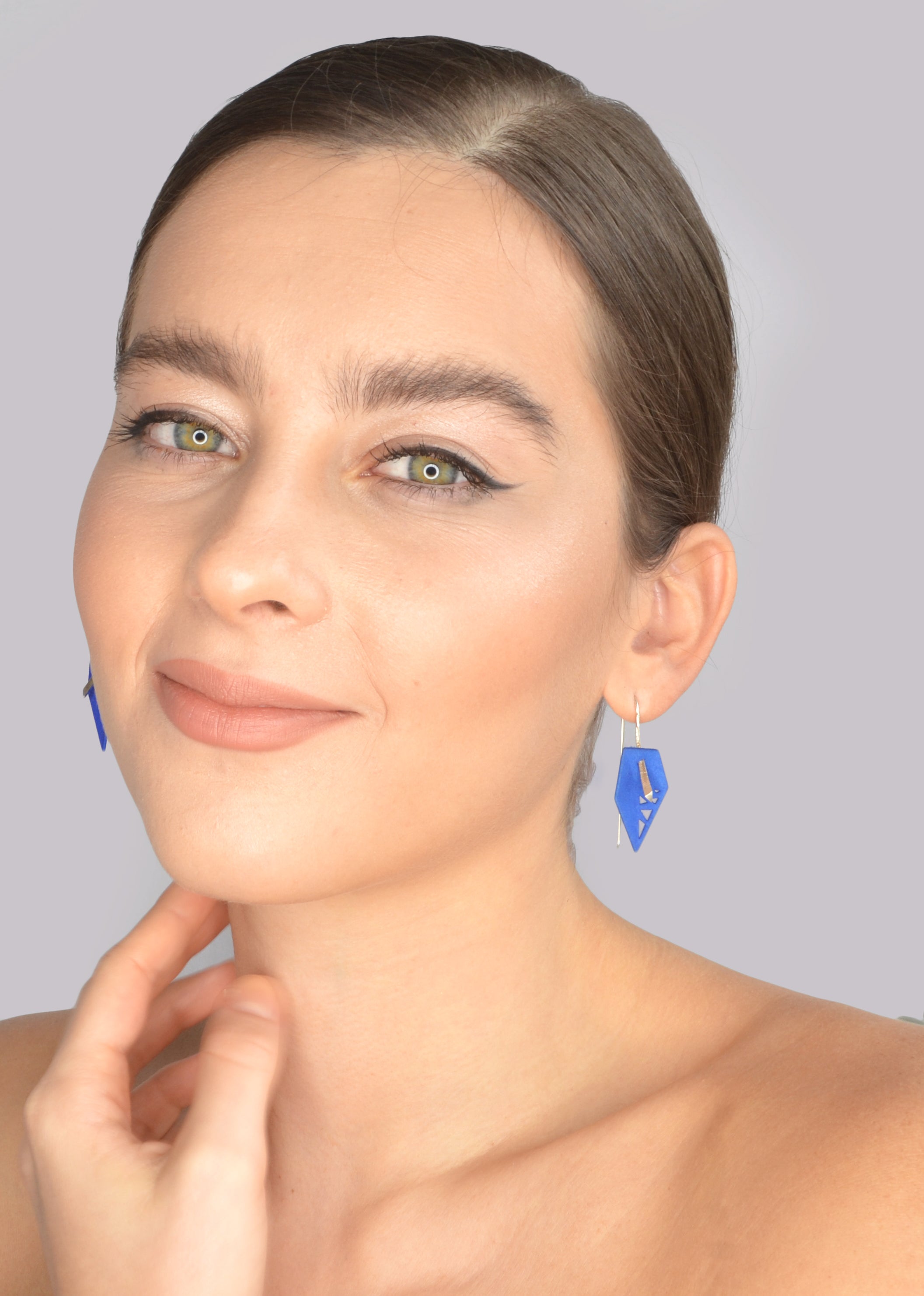 A pair of vibrant Geometric Drop Interchangeable Earrings in various colors, showcasing their unique teardrop design and lightweight structure.