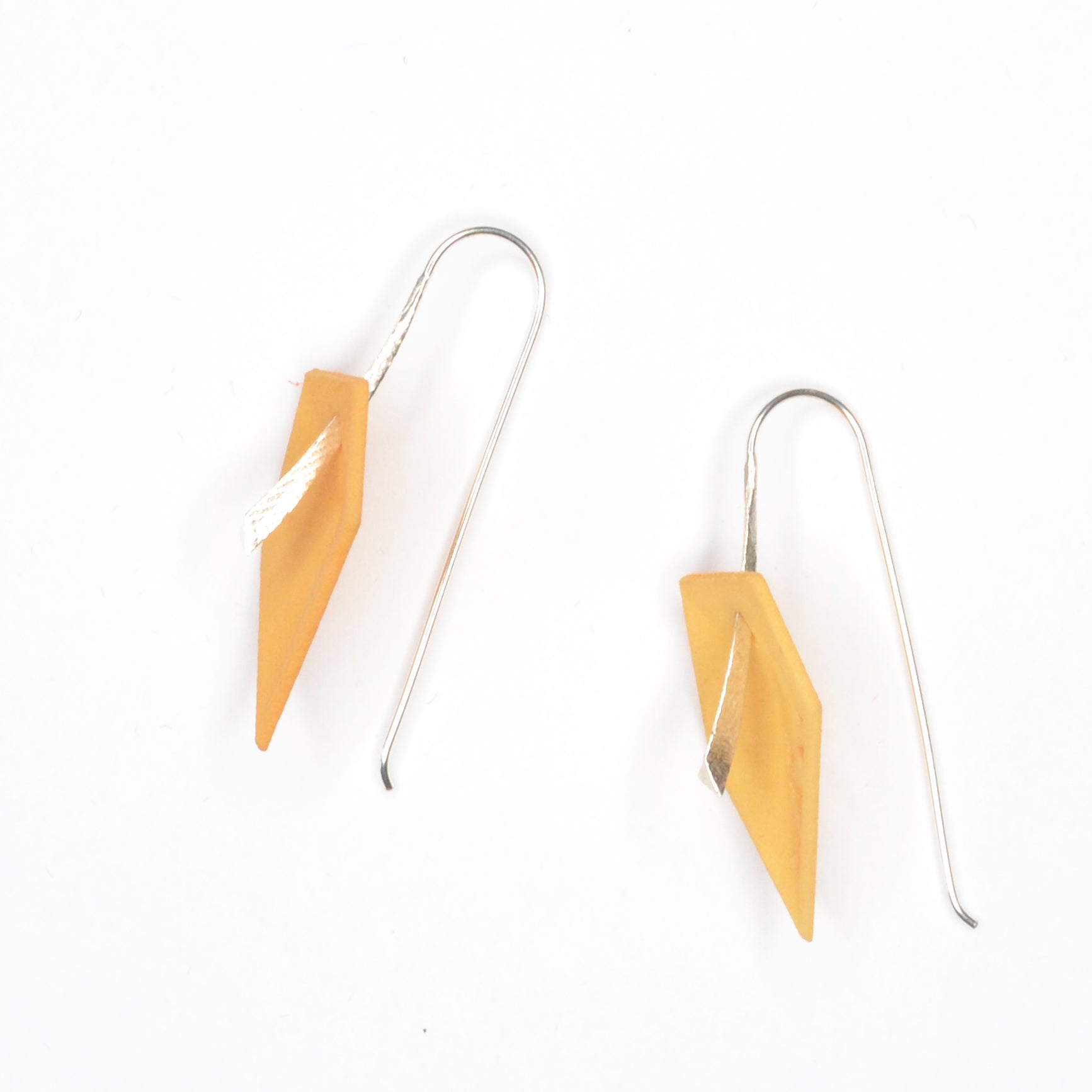 A pair of vibrant Geometric Drop Interchangeable Earrings in various colors, showcasing their unique teardrop design and lightweight structure.
