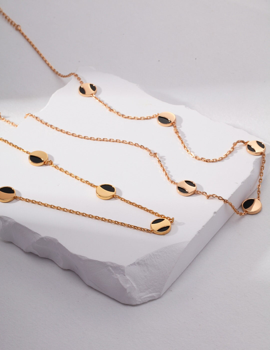 A stunning Geometric Round Black Onyx Necklace featuring a round black onyx pendant on a gold vermeil chain, elegantly displayed.