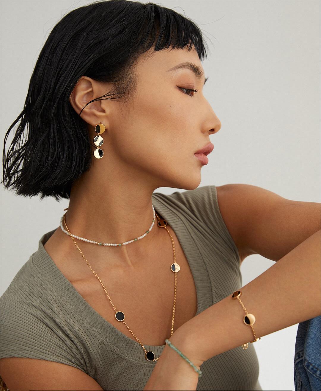 A stunning Geometric Round Black Onyx Necklace featuring a round black onyx pendant on a gold vermeil chain, elegantly displayed.