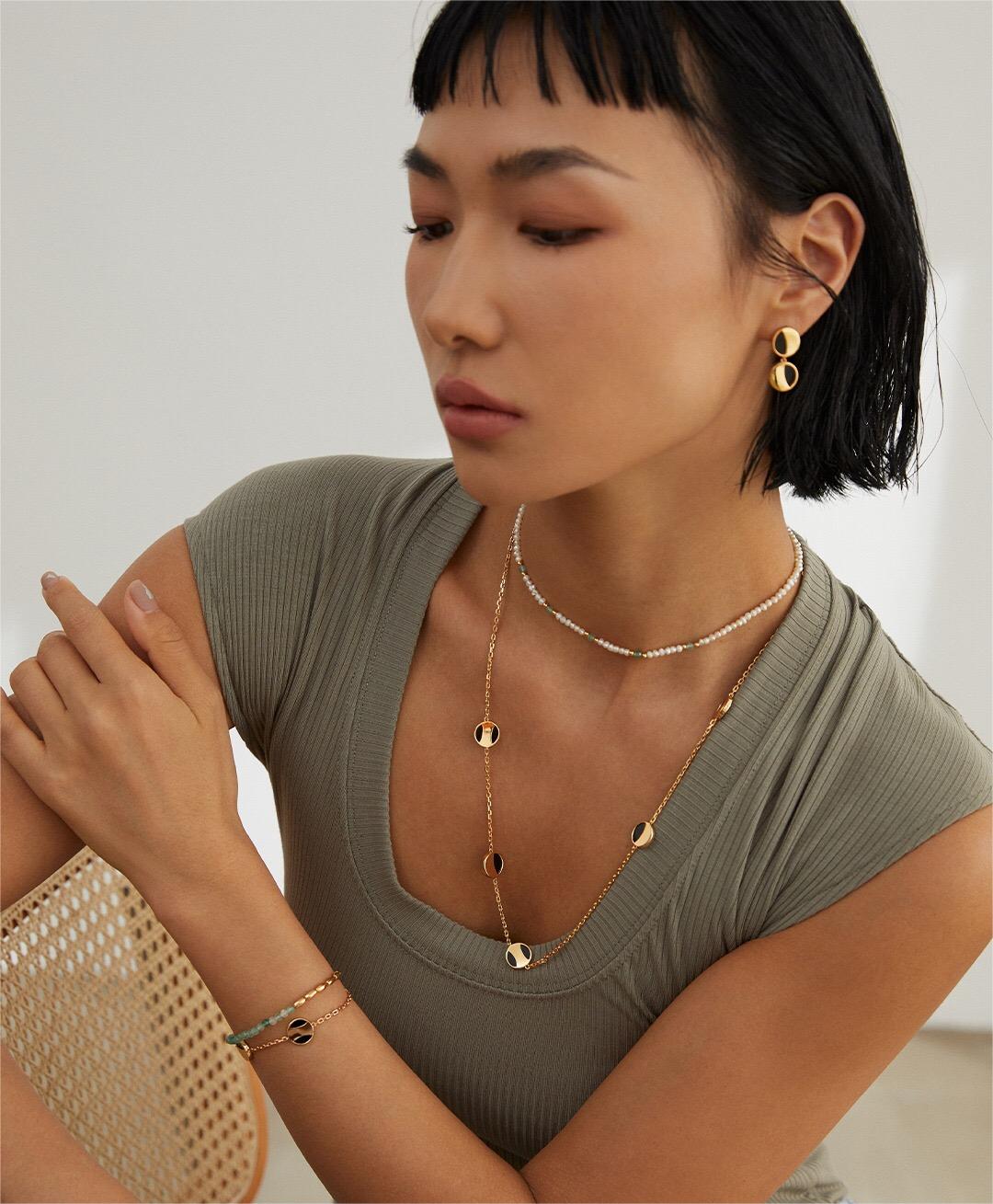 A stunning Geometric Round Black Onyx Necklace featuring a round black onyx pendant on a gold vermeil chain, elegantly displayed.