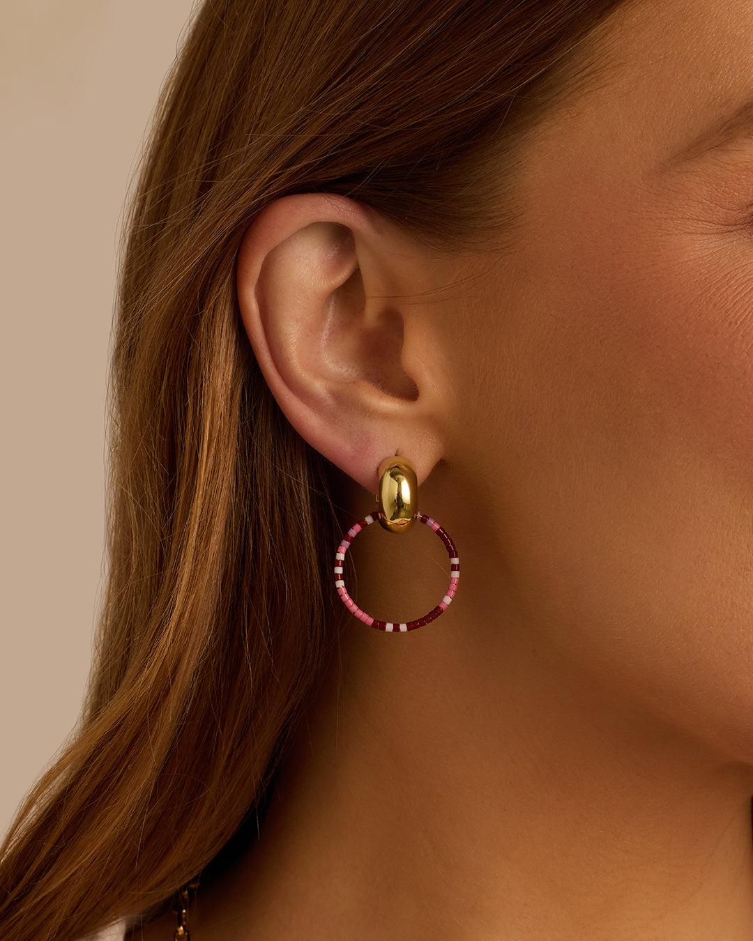 Elegant Gigi Drop Hoops in 14k gold, showcasing their stylish design and lightweight structure.