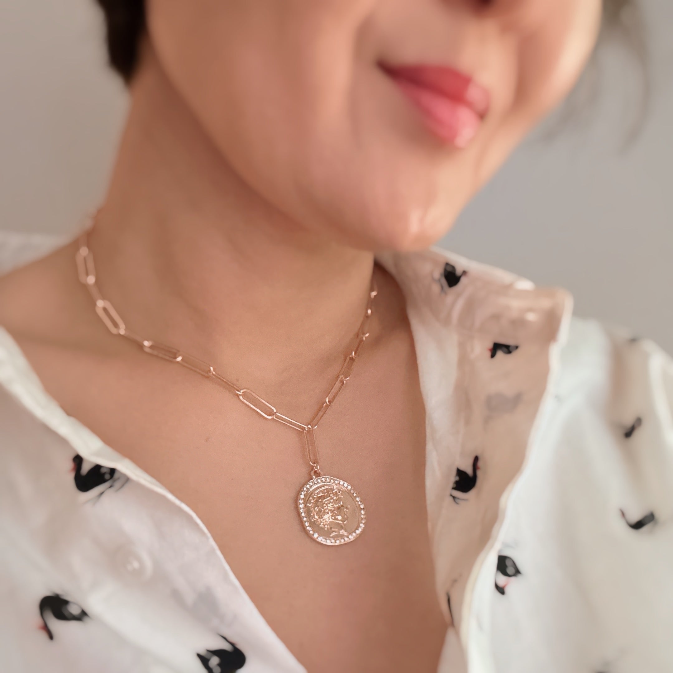 Glam Edge Coin Link Chain Necklace featuring a classic chain with a dangling coin charm, perfect for adding glamour to any outfit.