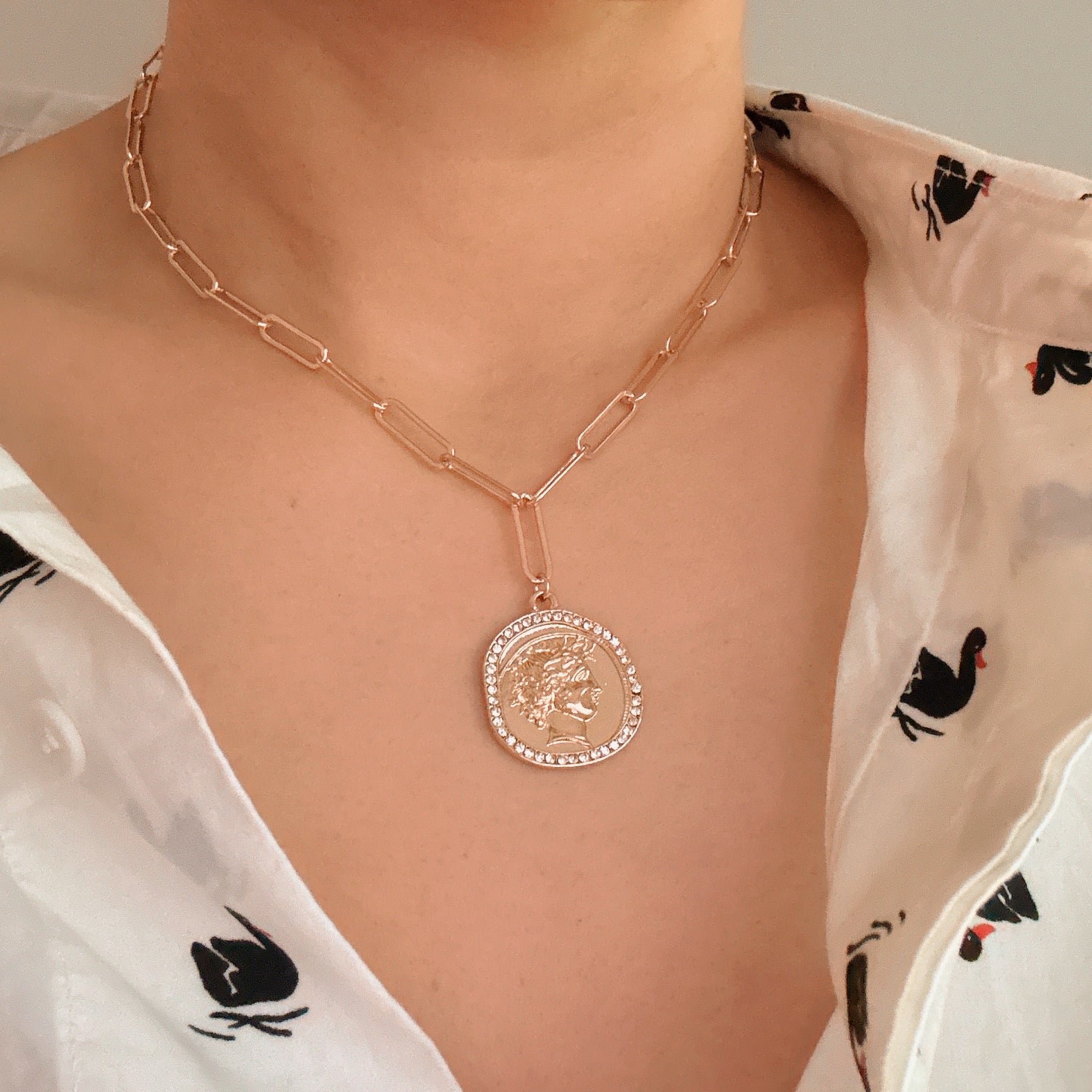 Glam Edge Coin Link Chain Necklace featuring a classic chain with a dangling coin charm, perfect for adding glamour to any outfit.