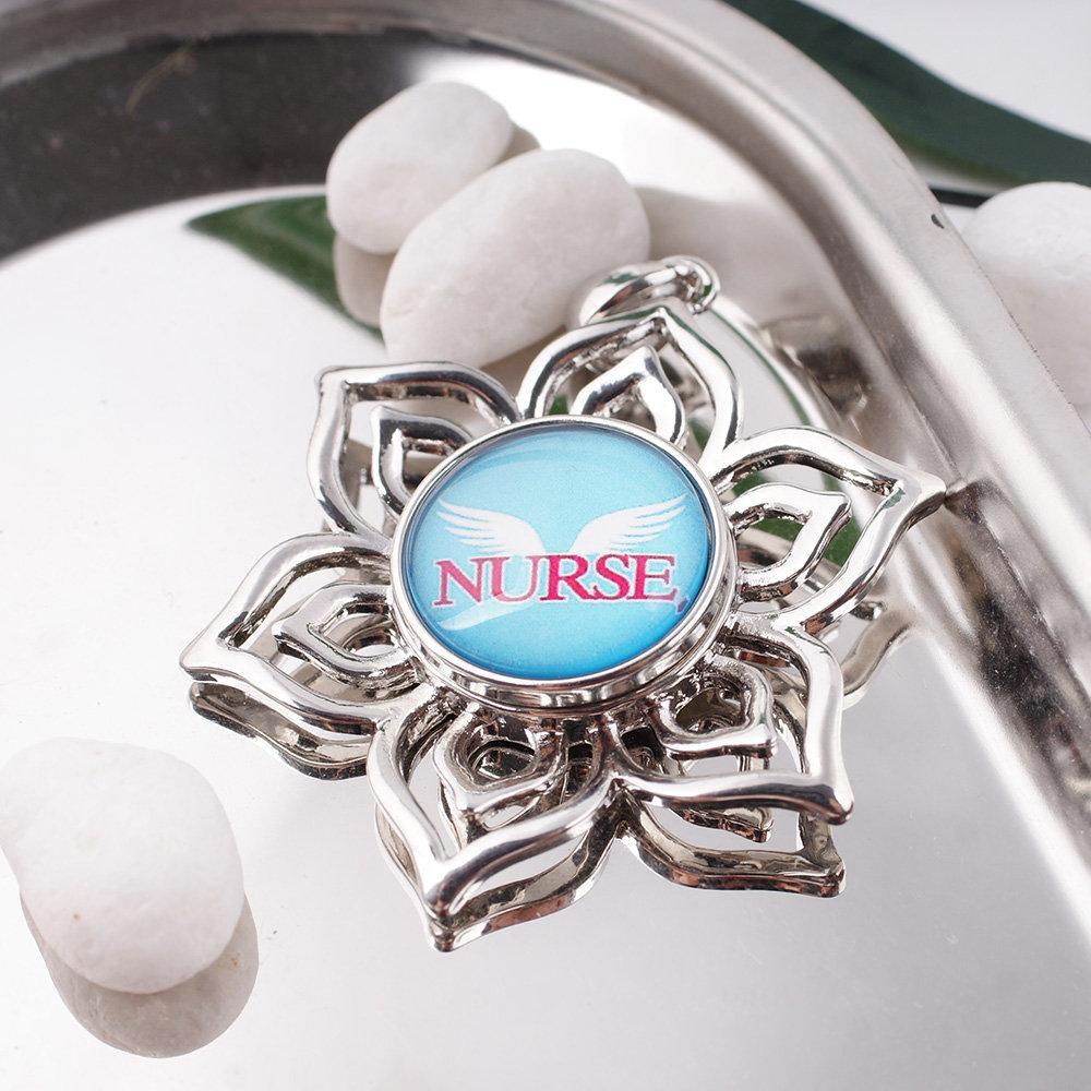 A beautiful Nurse with Wings snap jewelry piece featuring a magnifying glass dome, designed for interchangeable charm bracelets and necklaces.