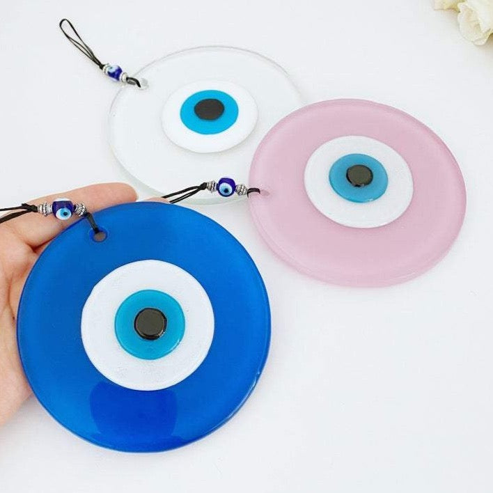 Handmade Glass Evil Eye Bead in pink and blue, perfect for baby room decor and protection, featuring a unique design.