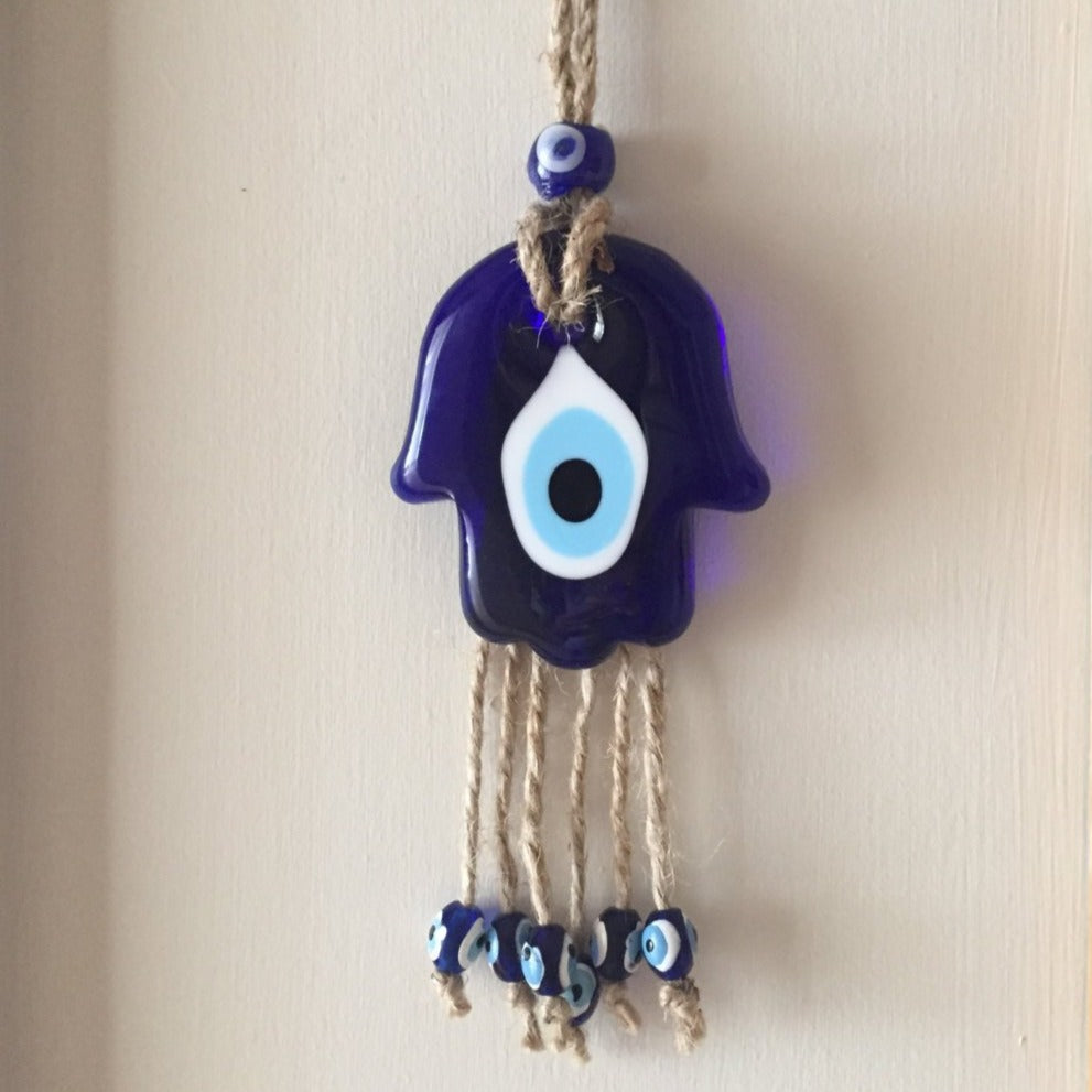 Handmade glass blue hamsa hand wall hanging with macramé design, symbolizing protection and good fortune.