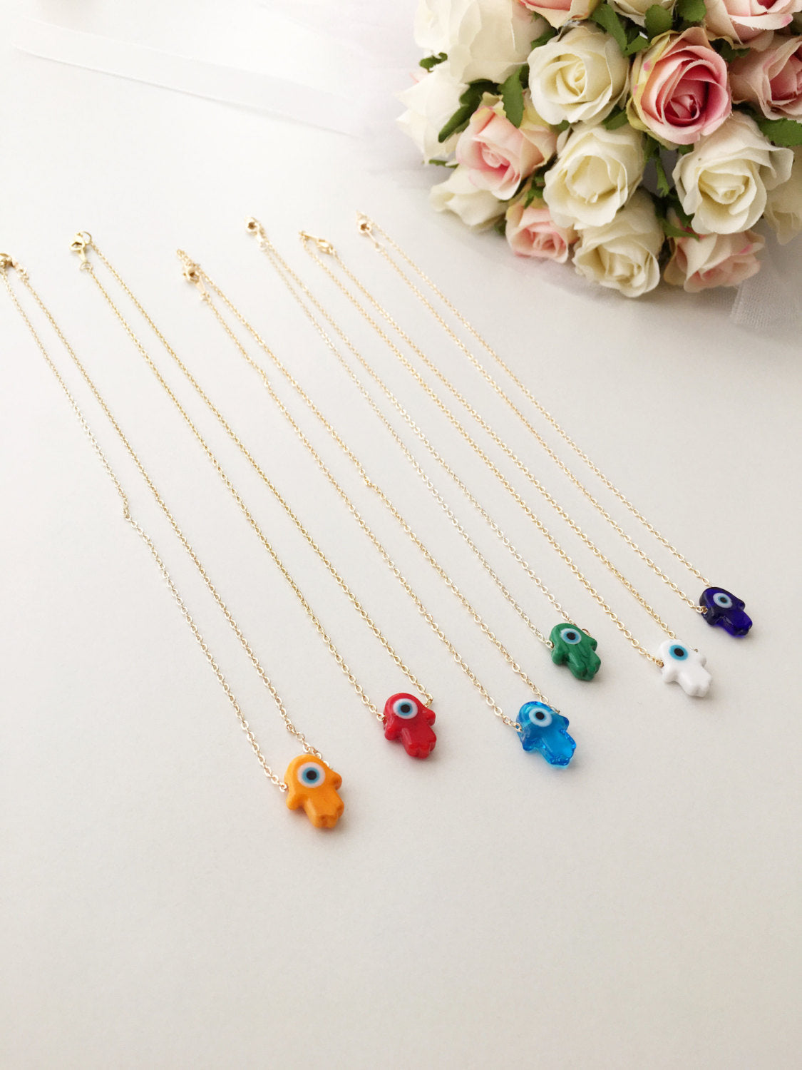 Handmade Glass Hamsa Necklace featuring an Evil Eye charm, available in multiple colors with gold or silver plated chain.