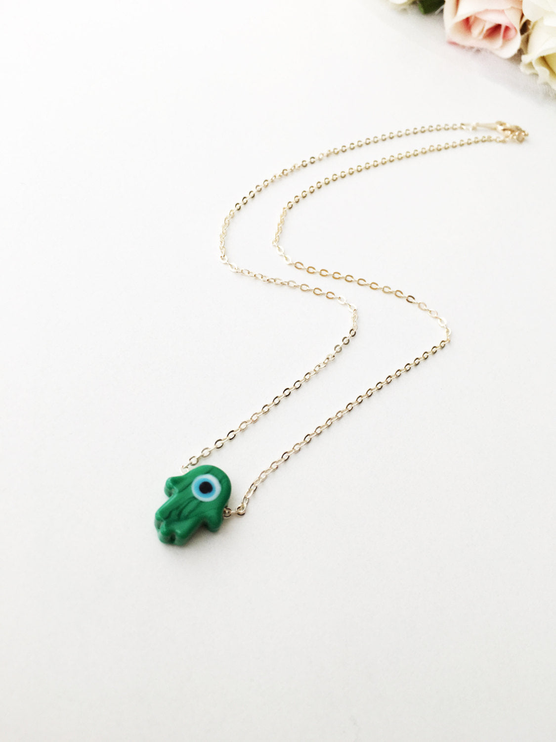 Handmade Glass Hamsa Necklace featuring an Evil Eye charm, available in multiple colors with gold or silver plated chain.