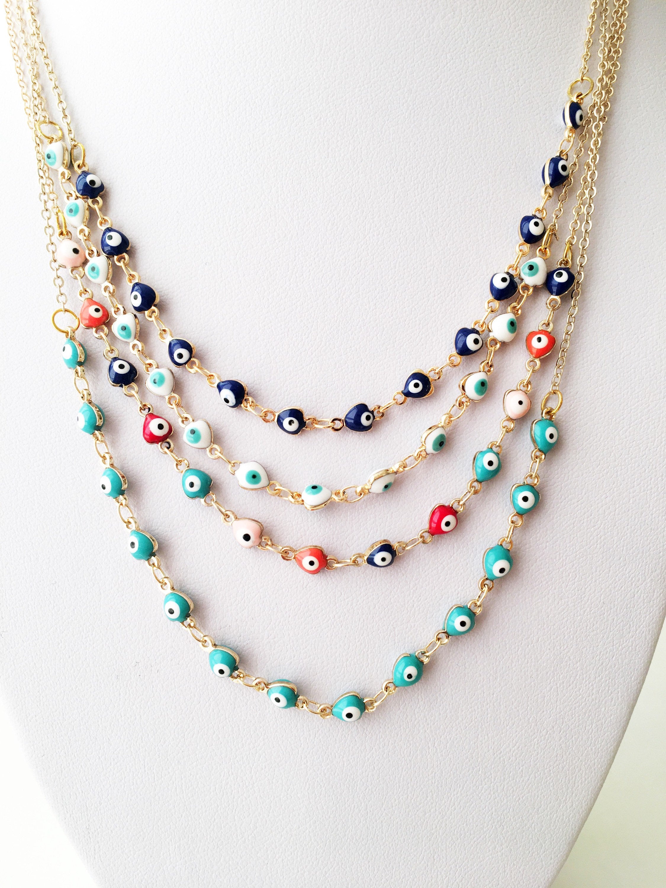 Gold Chain Evil Eye Necklace featuring tiny blue evil eye charms on a stainless steel chain, perfect for everyday wear.