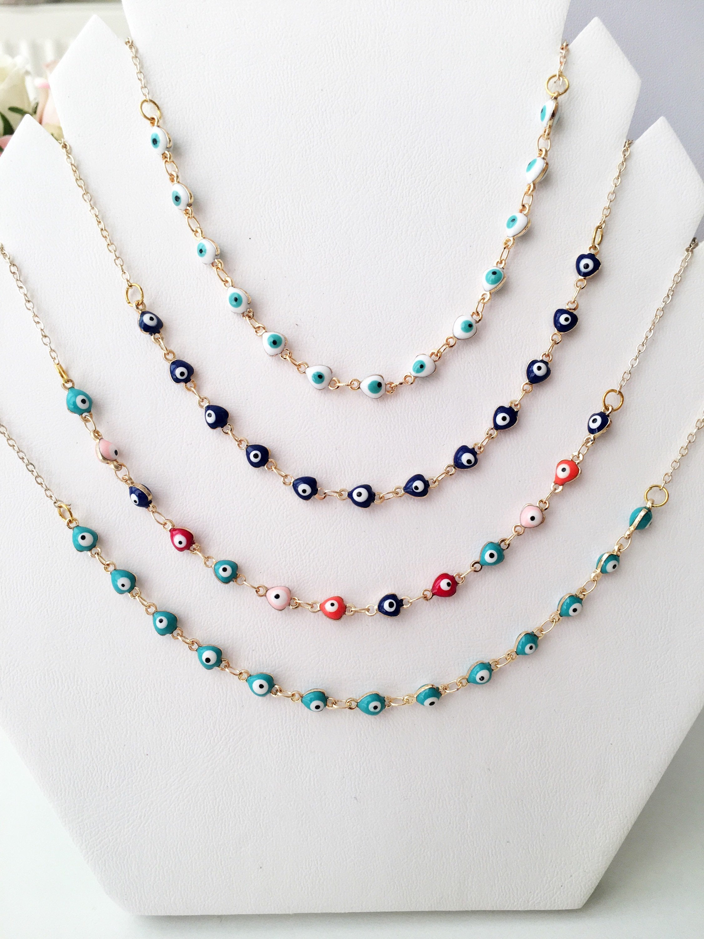 Gold Chain Evil Eye Necklace featuring tiny blue evil eye charms on a stainless steel chain, perfect for everyday wear.