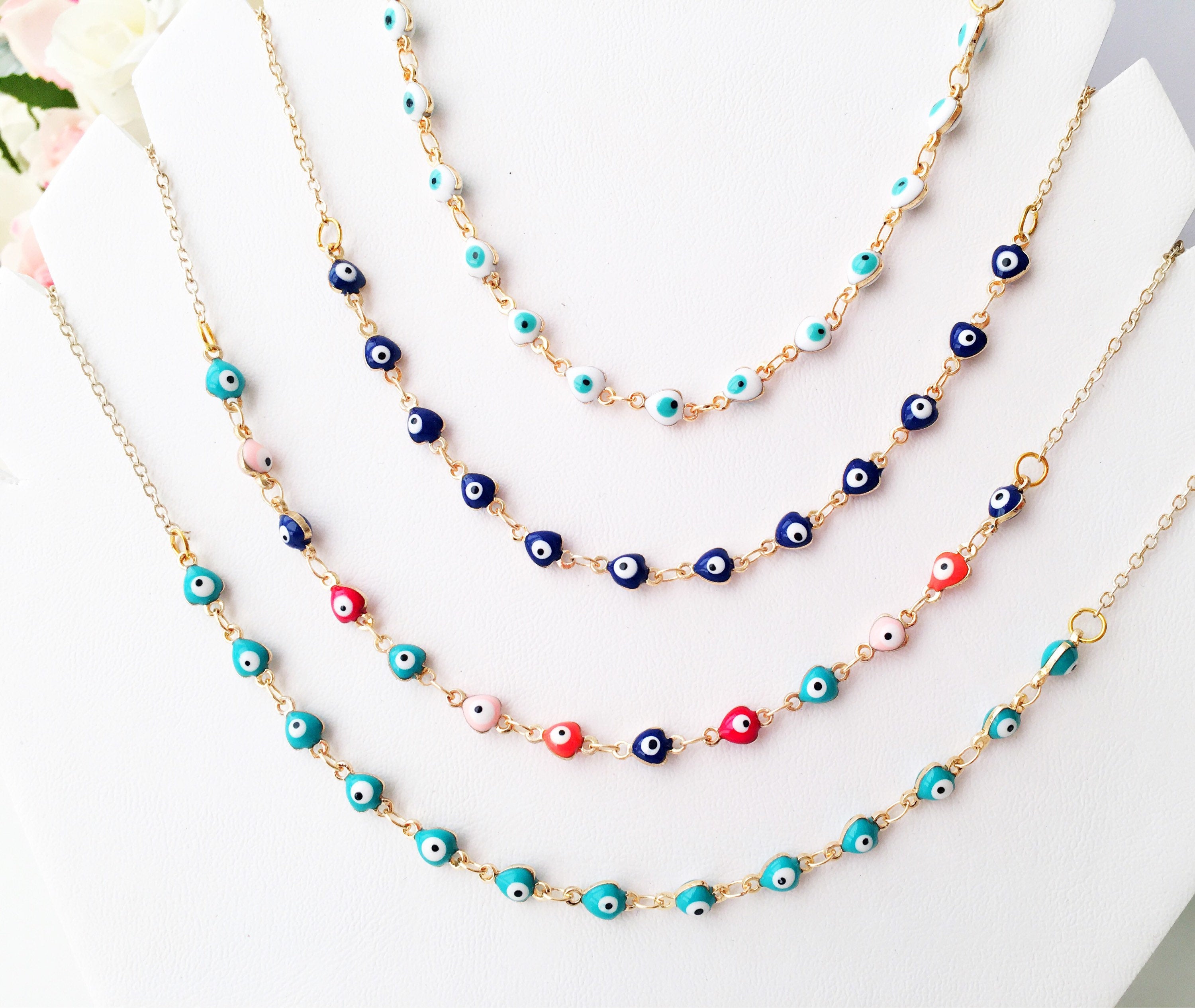 Gold Chain Evil Eye Necklace featuring tiny blue evil eye charms on a stainless steel chain, perfect for everyday wear.