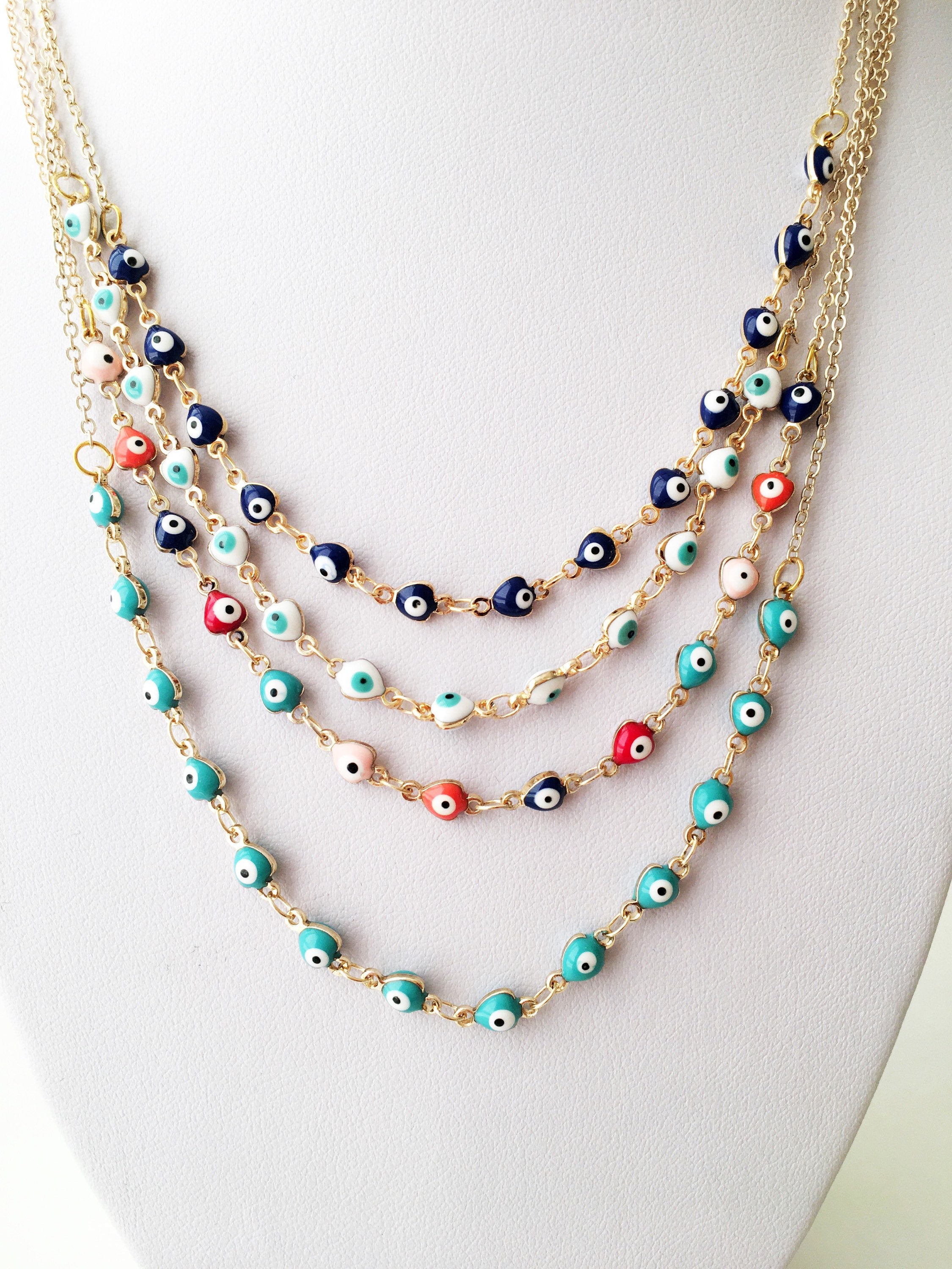 Gold Chain Evil Eye Necklace featuring tiny blue evil eye charms on a stainless steel chain, perfect for everyday wear.