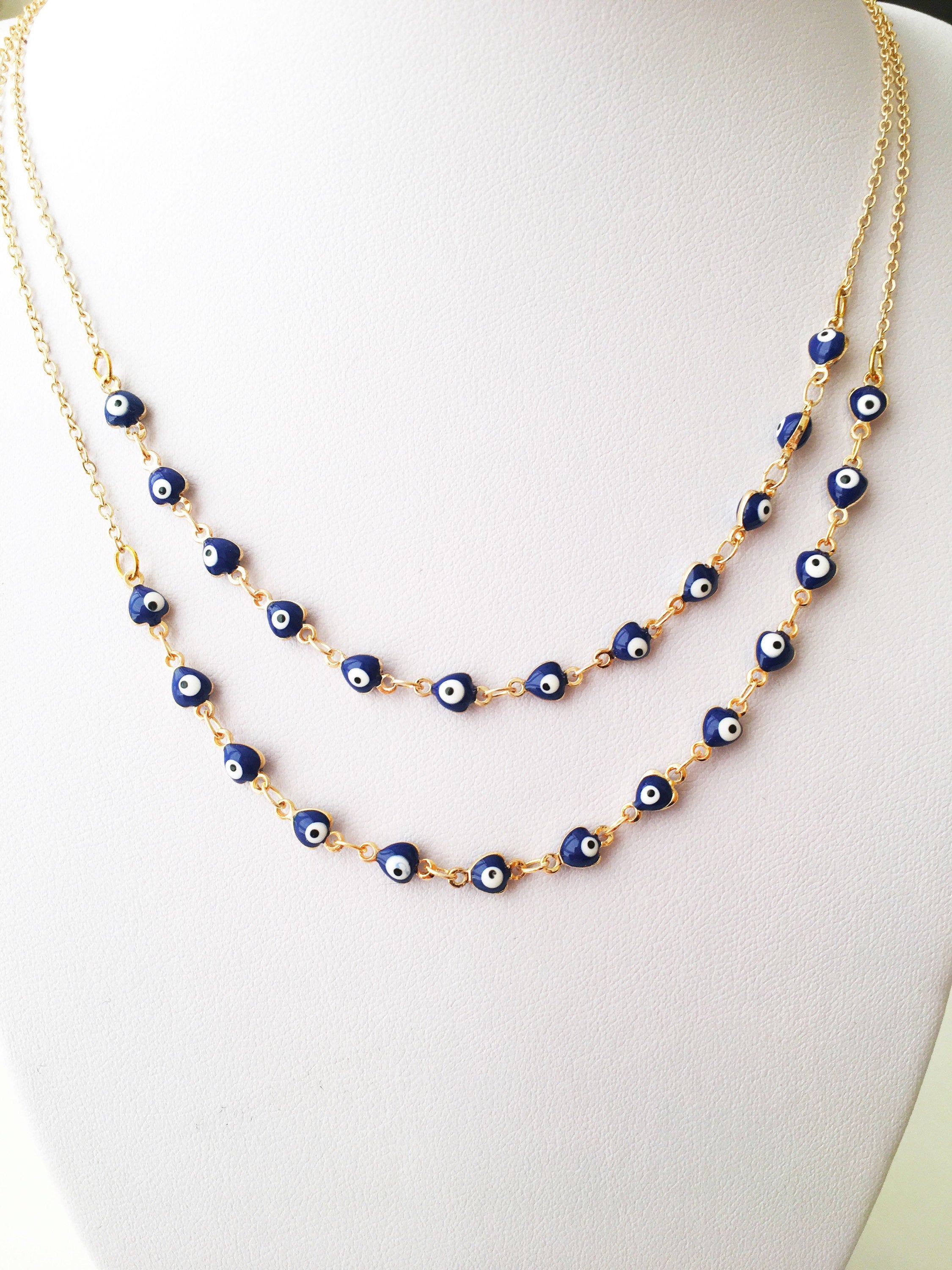 Gold Chain Evil Eye Necklace featuring tiny blue evil eye charms on a stainless steel chain, perfect for everyday wear.