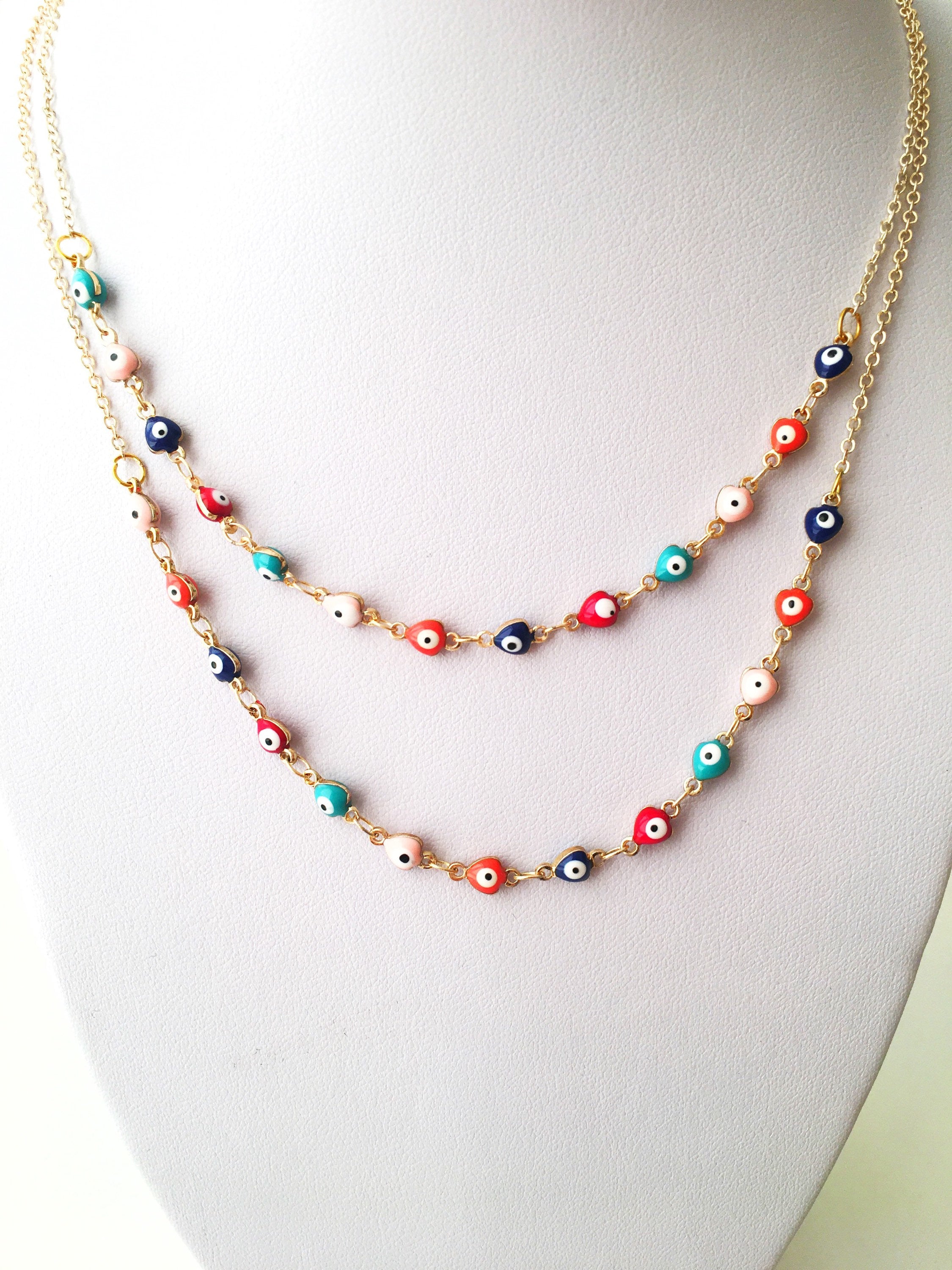 Gold Chain Evil Eye Necklace featuring tiny blue evil eye charms on a stainless steel chain, perfect for everyday wear.