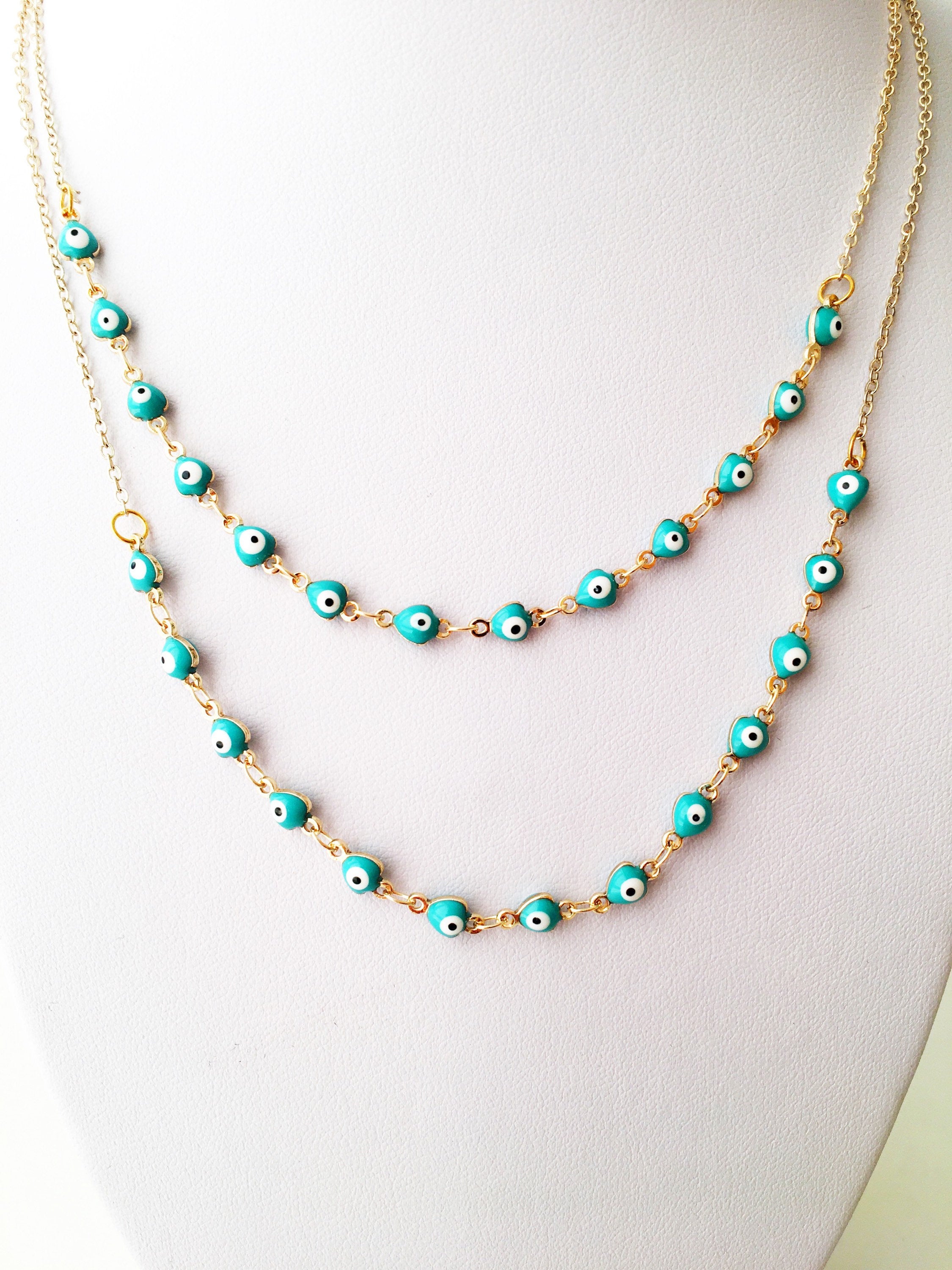 Gold Chain Evil Eye Necklace featuring tiny blue evil eye charms on a stainless steel chain, perfect for everyday wear.