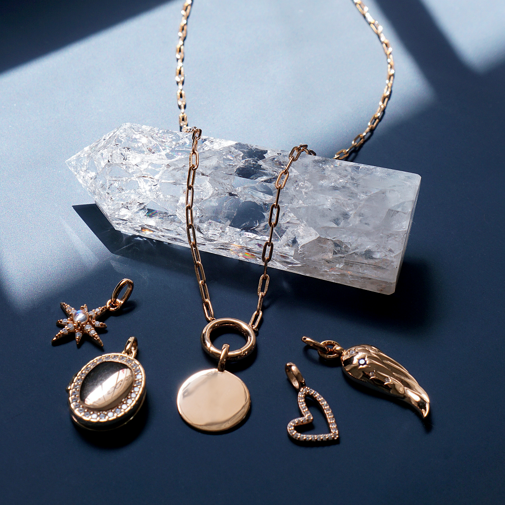 Gold Charm Carrier Necklace Chain with charms, showcasing its elegant design and versatility.