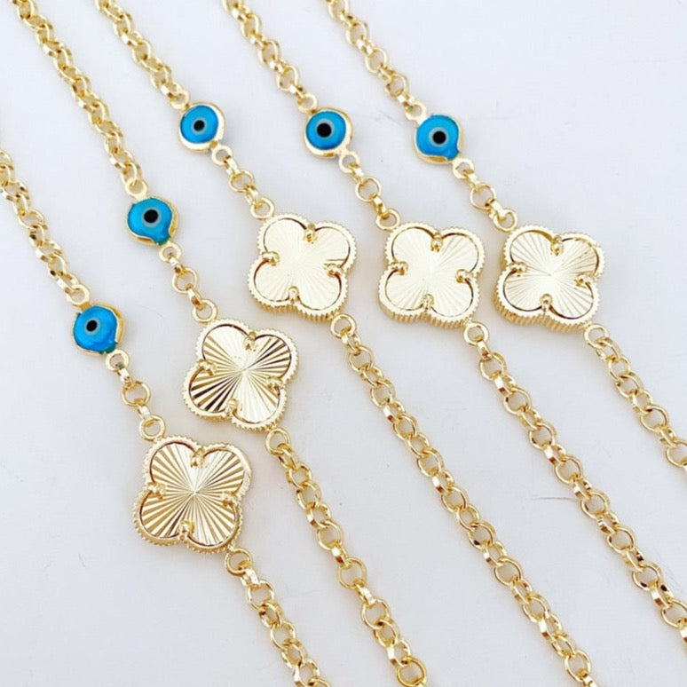 Gold Clover Bracelet featuring a blue evil eye bead and lucky clover charm, handmade with intricate details.