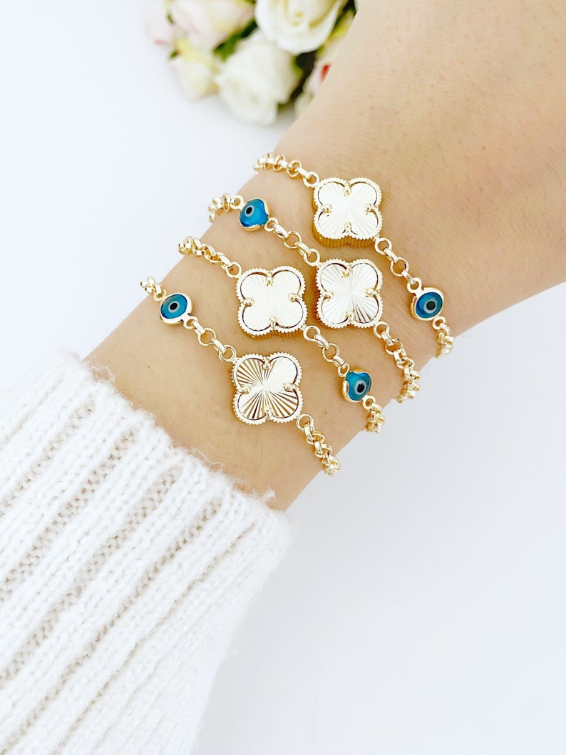 Gold Clover Bracelet featuring a blue evil eye bead and lucky clover charm, handmade with intricate details.