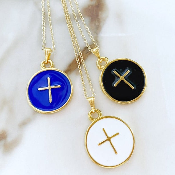 A beautiful Gold Enamel Cross Necklace featuring a handmade cross pendant available in blue, white, and black, hanging from a 16-inch chain.