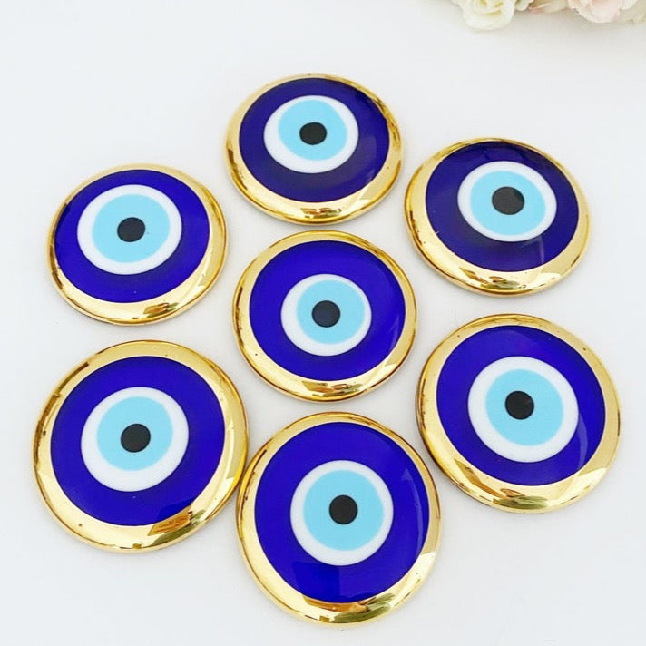 A beautiful 7 cm Gold Evil Eye Bead made of Murano glass, featuring an elegant design with no hole, perfect for wedding favors and home decor.