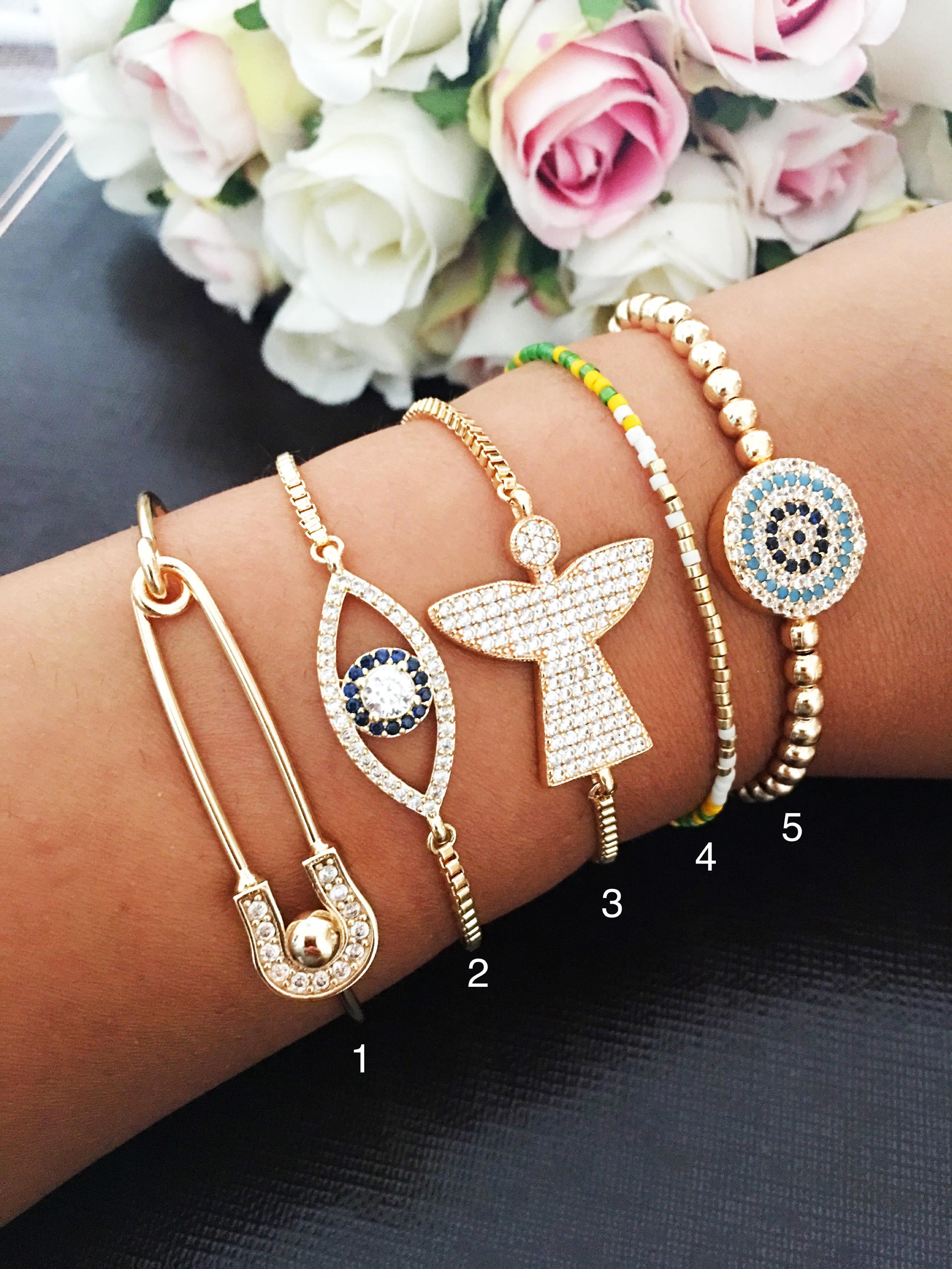 A beautiful handmade Gold Evil Eye Bracelet featuring Miyuki beads and zirconia, showcasing its adjustable design and intricate details.