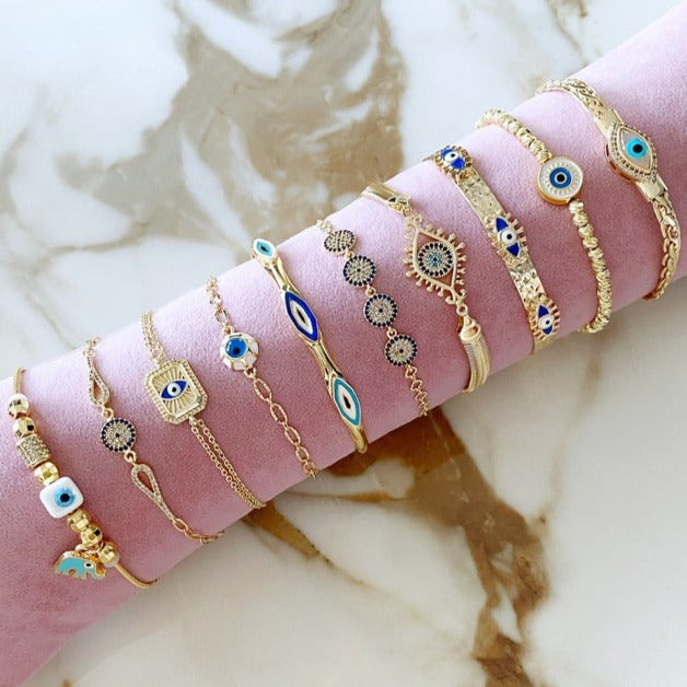 A beautiful Gold Evil Eye Bracelet featuring a chain design, adjustable fit, and a protective evil eye talisman, handmade from tarnish-resistant stainless steel.