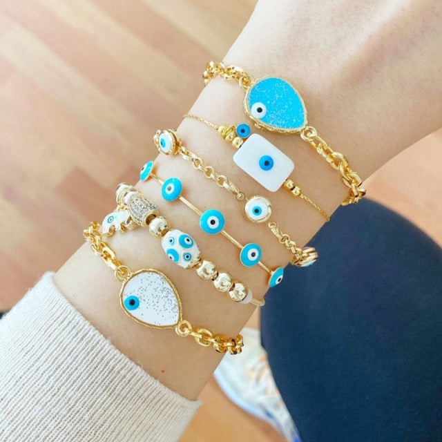 Gold Evil Eye Bracelet featuring a blue evil eye design, adjustable cuff style, handmade with tarnish-resistant stainless steel.