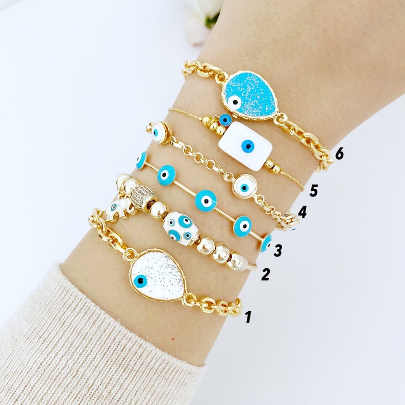 Gold Evil Eye Bracelet featuring a blue evil eye design, adjustable cuff style, handmade with tarnish-resistant stainless steel.