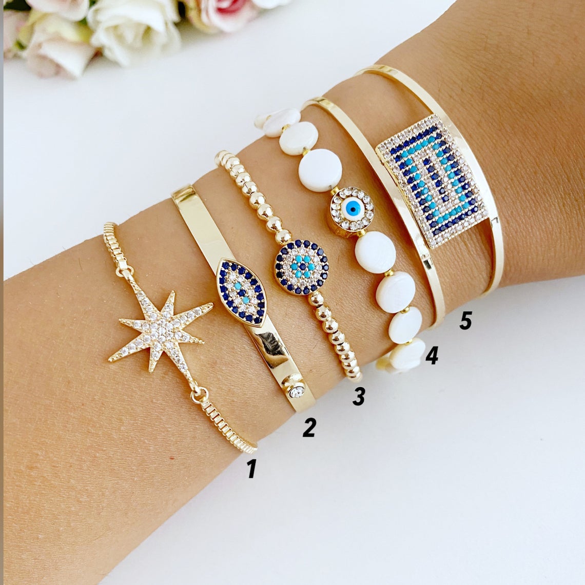 Gold Evil Eye Bracelet featuring a movable oval charm and adjustable cuff design, handmade with tarnish-resistant stainless steel.