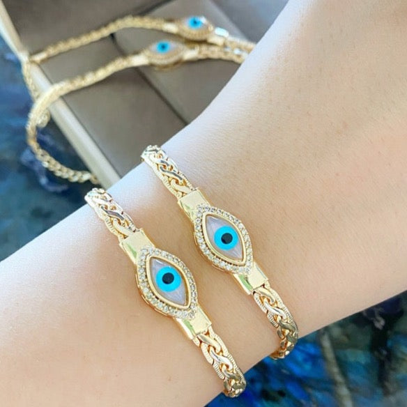 Gold Evil Eye Bracelet featuring a foxtail chain and MOP charm, showcasing its elegant design and adjustable fit.