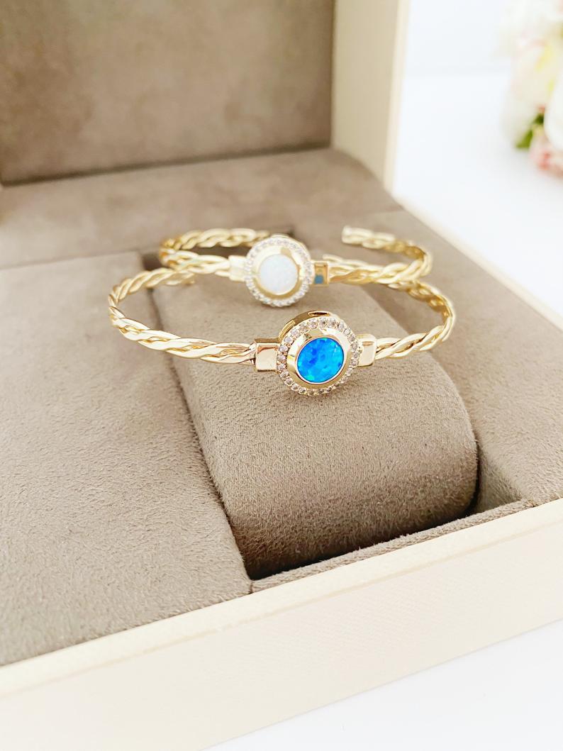 Gold Evil Eye Bracelet featuring blue and white opal beads, handmade with adjustable stainless steel material.