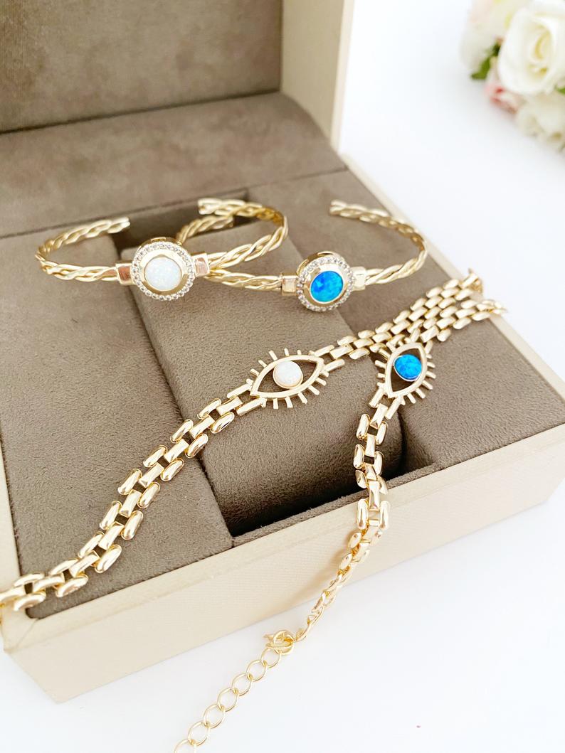 Gold Evil Eye Bracelet featuring blue and white opal beads, handmade with adjustable stainless steel material.