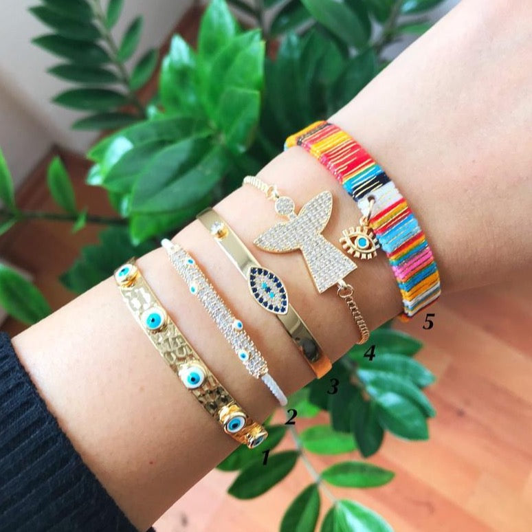 Gold Evil Eye Bracelet Set featuring adjustable bangles with unique designs, handmade from tarnish-resistant stainless steel.