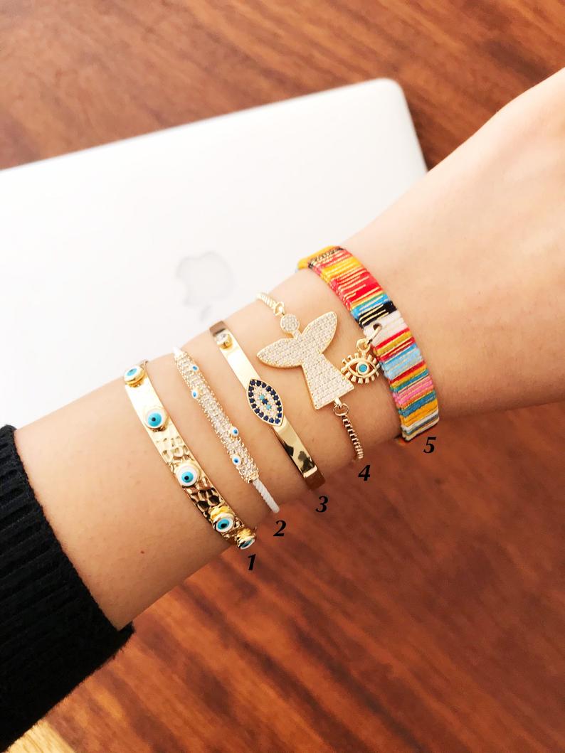Gold Evil Eye Bracelet Set featuring adjustable bangles with unique designs, handmade from tarnish-resistant stainless steel.