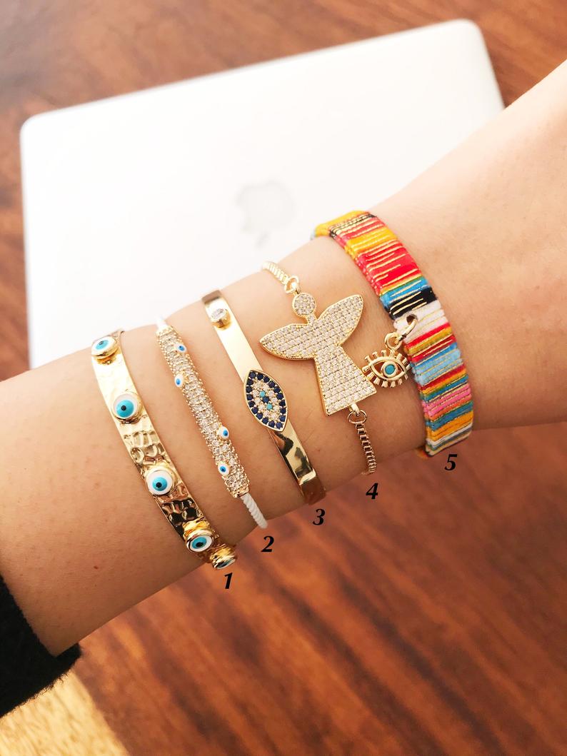 Gold Evil Eye Bracelet Set featuring adjustable bangles with unique designs, handmade from tarnish-resistant stainless steel.